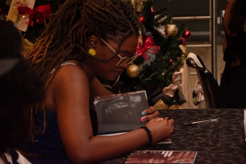 Fotografia Colorida Lu Varello no lançamento do livro “Eternizar em Escrita Preta”